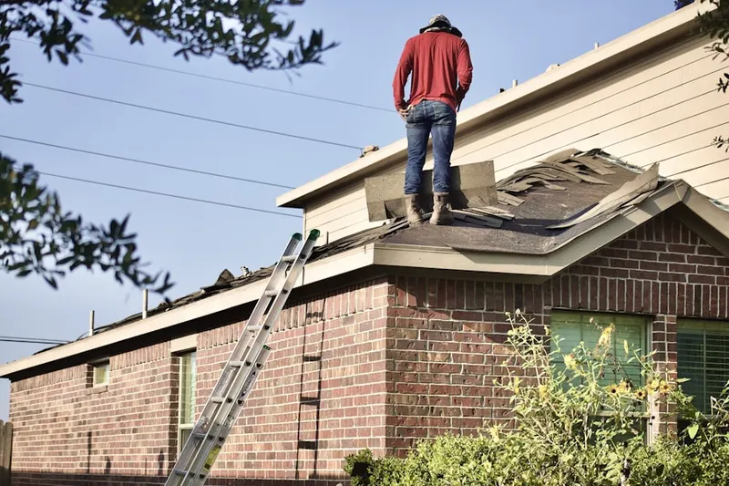 Professional roofer working on a residential roof in Burnham